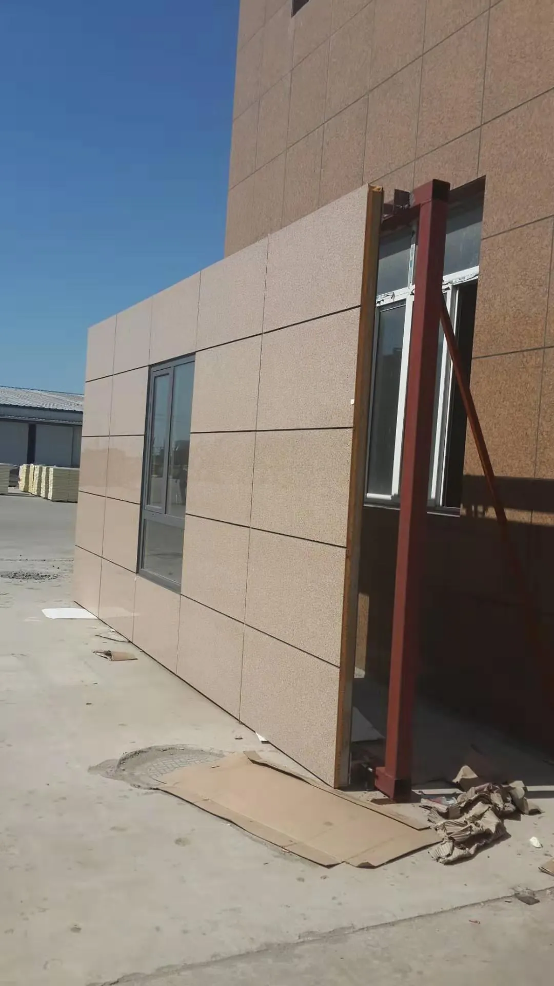 建筑转角处安装完成的米色一体板外墙