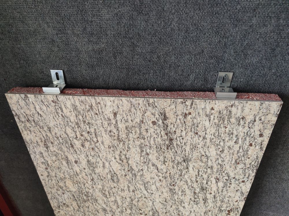 Natural stone faced insulated panel sample — thin granite facing laminated onto an insulation core